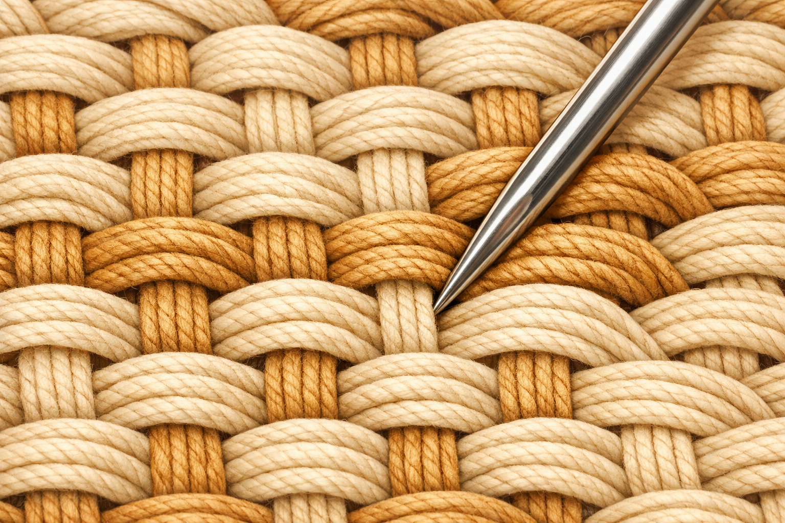 Needle tip pushes woven rows together to make a dense, even patch.