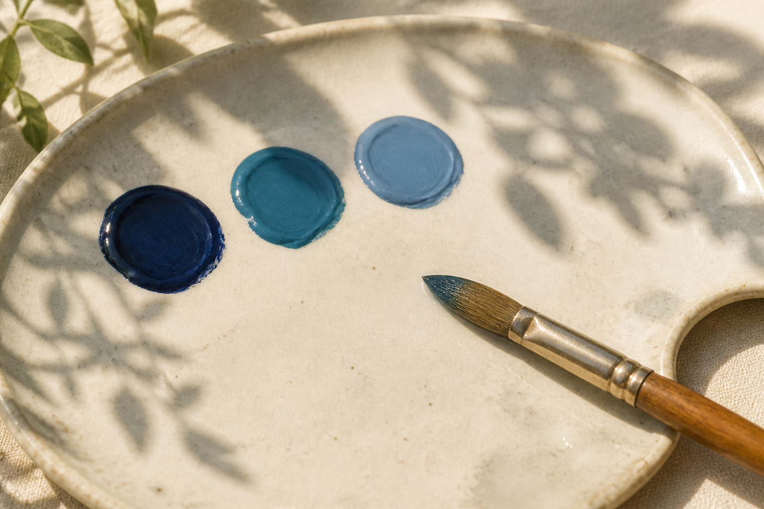 Palette with three mixed night-sky colors (dark blue, blue-teal, lighter blue) and a brush.