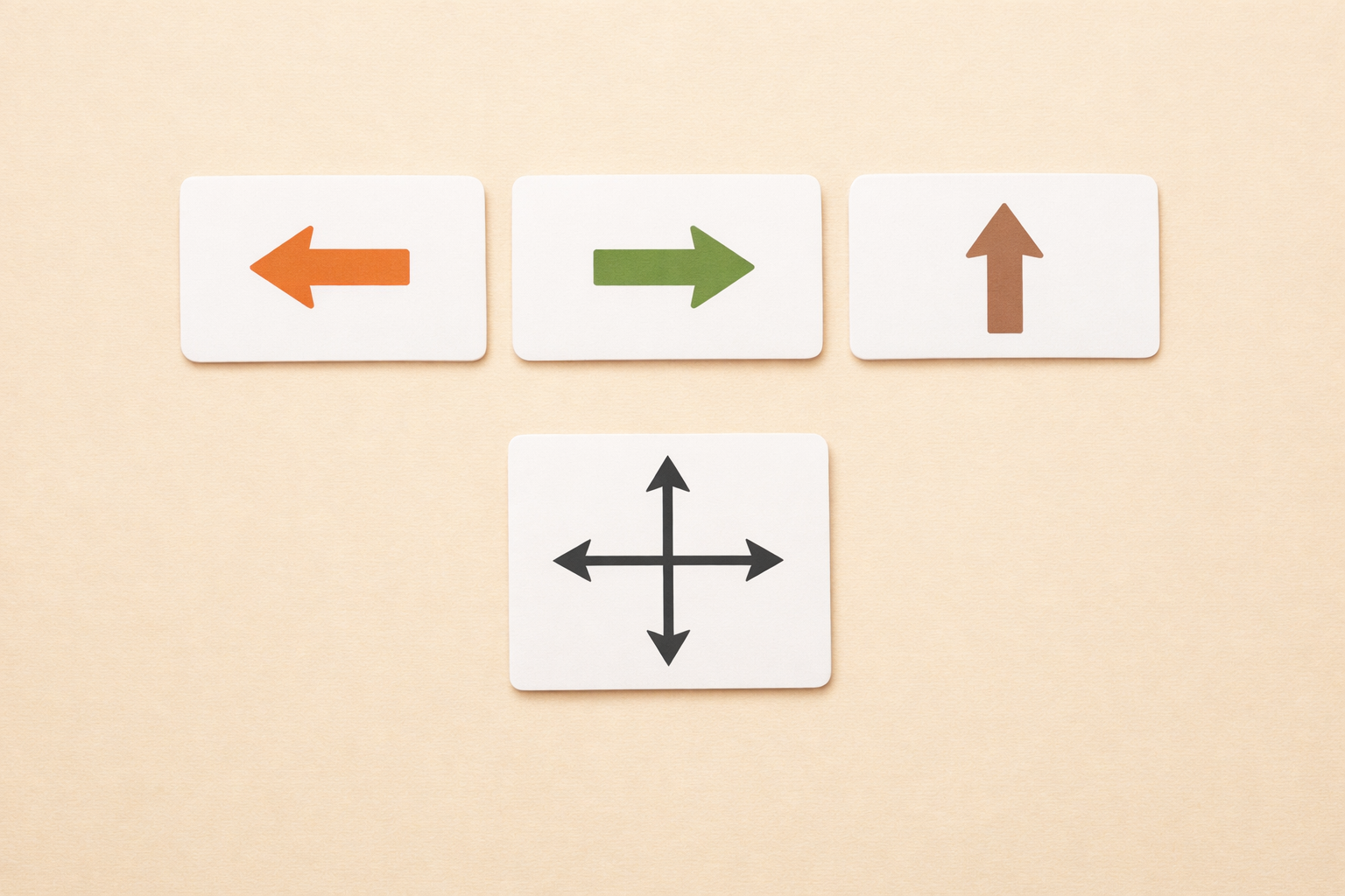 Blank flashcards with arrow icons and a compass symbol laid out on a table.